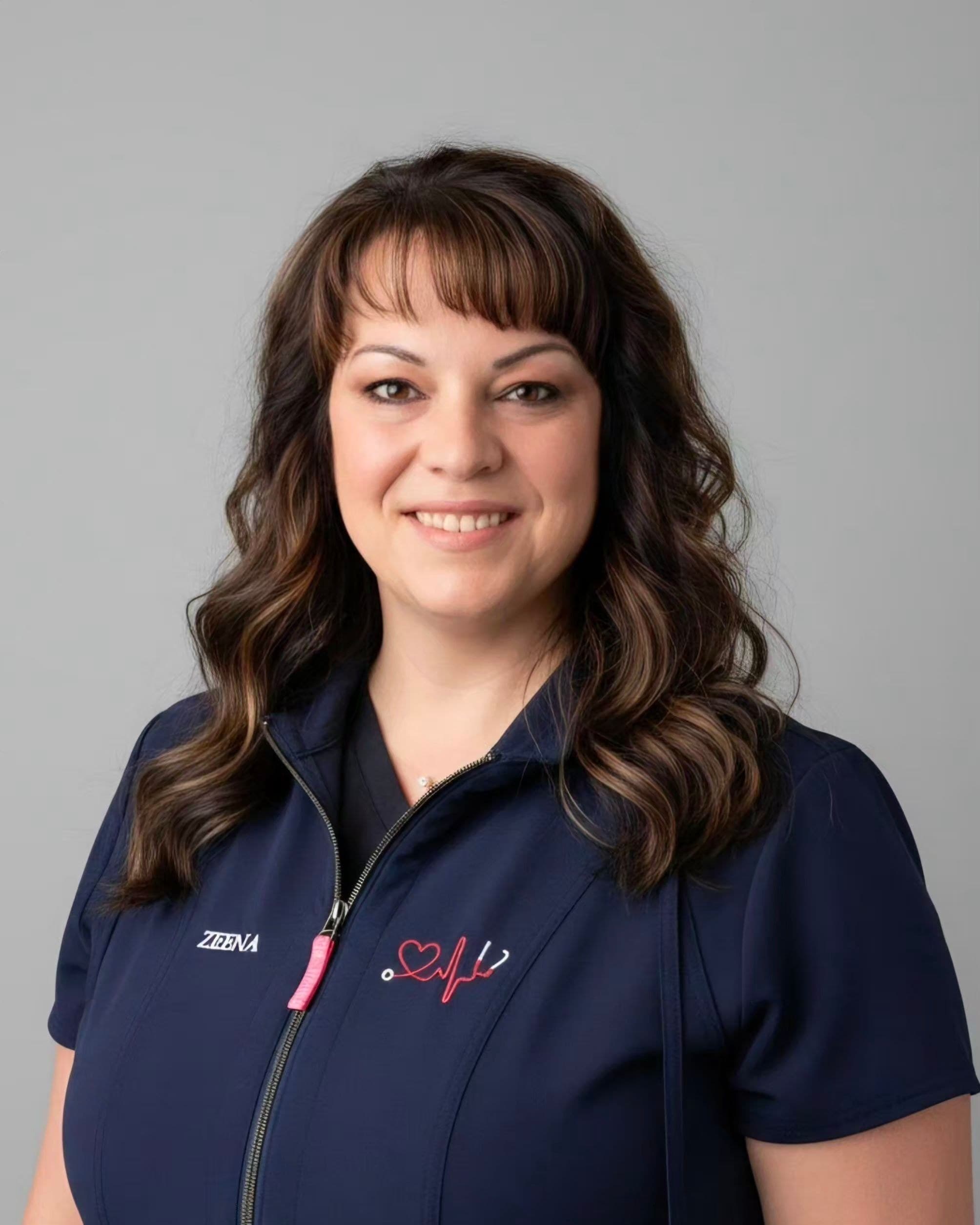 Zeena LaBrecque, smiling, in a navy top.